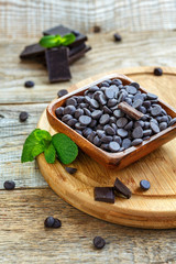 Wooden bowl with dark chocolate.