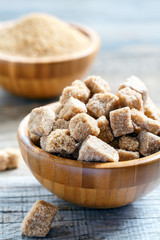 Natural cane sugar cubes in a wooden bowl.