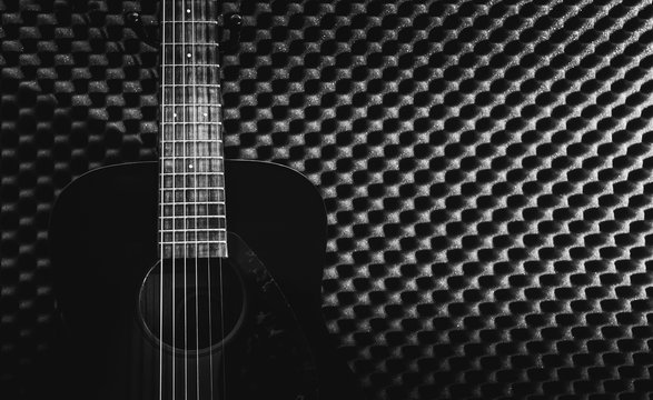 acoustic guitar in recording studio for music background. black and white