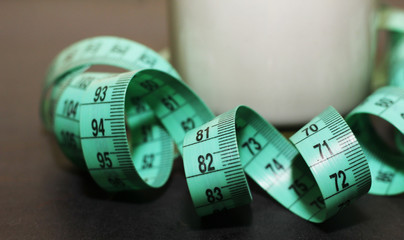 glass of kefir and tape measure
