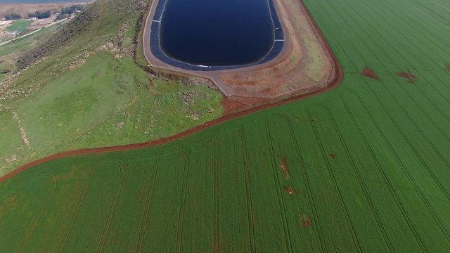 Water reservoir on top of a cliff, overlooking the sea of Galilee - Aerial footage