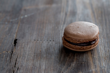 Chocolate macarons on a rustic wooden table