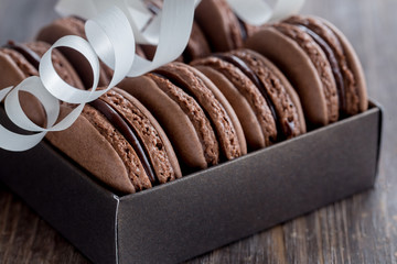 Chocolate macarons on a rustic wooden table