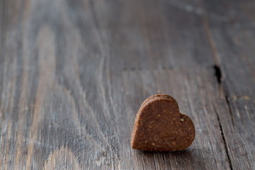Obraz na płótnie Canvas Valentine's chocolate heart cookies on black wooden old background