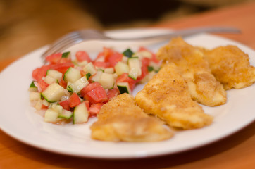 Grilled cheese with a salad of tomatoes and cucumbers