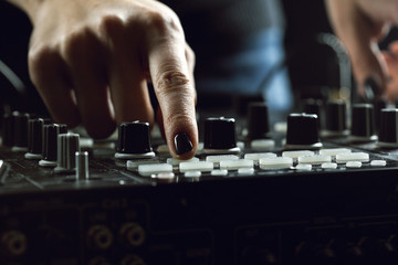 DJ playing music at mixer closeup