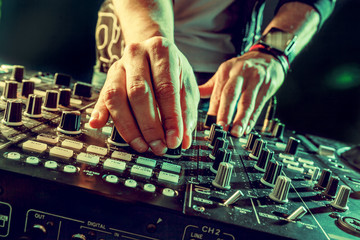 DJ playing music at mixer closeup