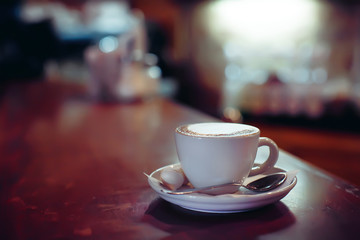 Cup of cappuccino on the table, blurry background