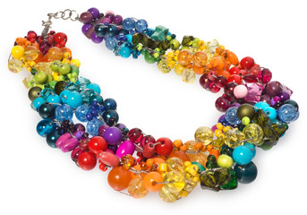 Necklace with multi-colored crystals and beads. Beads and crystals shining and glowing interspersed with silver thread in kolrach: blue, blue, yellow. Beads on a white background.