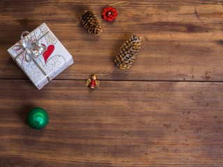 Vintage gift box, fir cones with Christmas toy on wood background with copy space for text. Top view, Studio photography