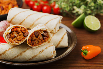 Burritos wraps with meat, beans and vegetables.