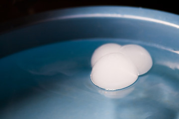 Abstract shot with big soap bubbles on a water surface with smoke insids