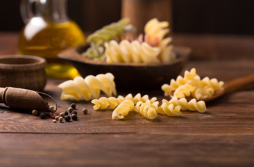 fusilli pasta on rustic  wooden background