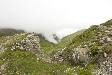 Landscape from Bucegi Mountains, part of Southern Carpathians in Romania in a very foggy day