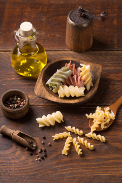 fusilli pasta on rustic  wooden background