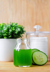 Cucumber juice in a small glass jar for preparing natural facial toner. Homemade cosmetics.