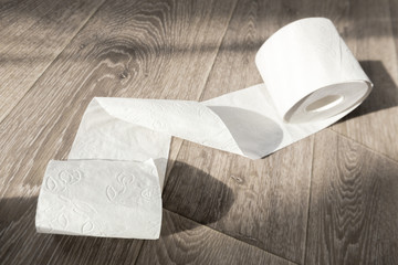 Toilet paper on wood background