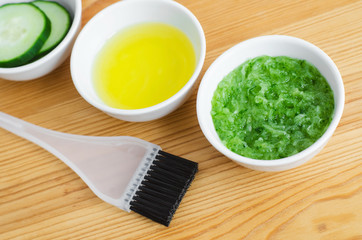 Grated cucumber in a small ceramic bowl for preparing natural facial mask. Homemade cosmetics.