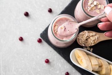 Smoothie of banana and cranberries with yogurt and oats 