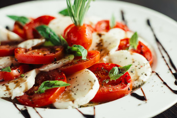 Appetizer with feta and tomatoes on dish