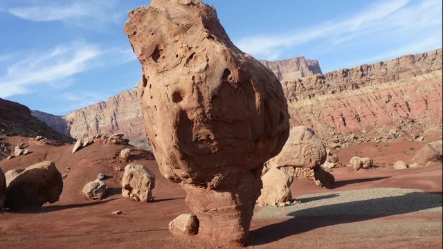 Zooming timelapse of people walking around large stones, at a red desert , that looks like the planet mars, near marble canyon, in Arizona, United states of America
