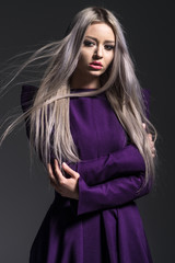 Young beautiful woman in dress on dark background