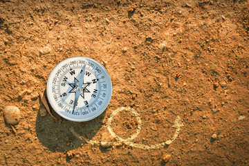Fototapeta na wymiar compass on earth with arrows, Find the best way concept, flat top view