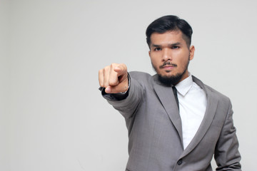Serious Caucasian businessman with black hair in business formal outfit waving finger