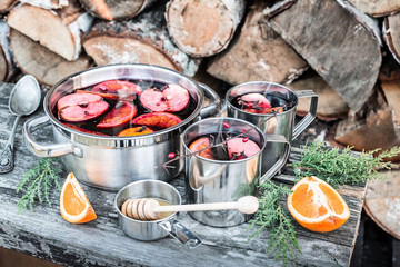 Hot mulled wine outdoor in a pot - winter or autumn picnic