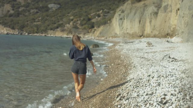 Beautiful girl walking on the beach