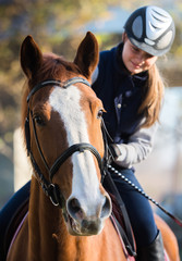 Young girl riding a horse