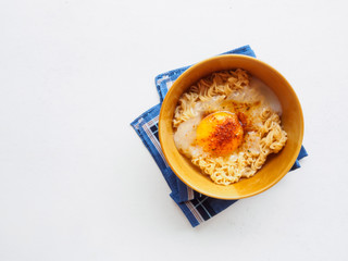 Top view bowl of noodle and soft egg boiled with blue  napkin on
