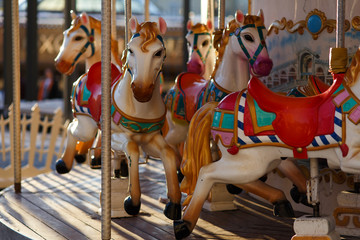 Infant carousel with workhorses outdoors