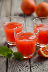 Fresh blood orange juice, selective focus, vertical.