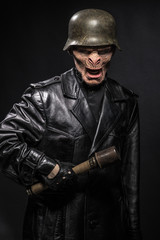 Fototapeta premium Angry baboonish man in black clothes on dark background