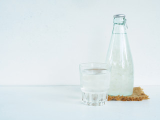 Bottle and  glass health drink of grape juice or aloe vera on wh