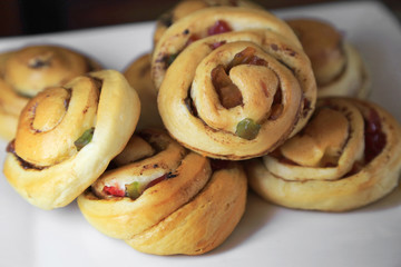 Obraz na płótnie Canvas Sweet bun roll swirl breads with dried fruit and cinnamon.