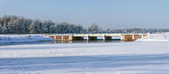 A small bridge on a frozen winter lake.