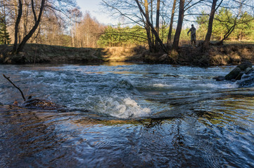Spring river flowing in a valley.