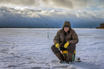 Fisherman on ice fishing