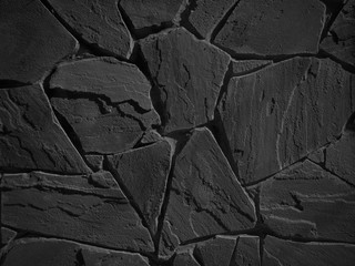 Black color decorative uneven cracked real stone wall