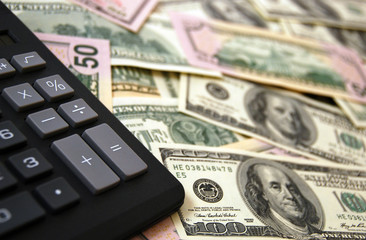 Calculator on money background