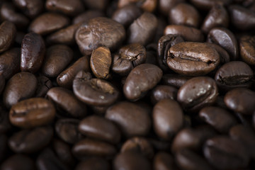 Stock Photo - Lonely woman drinking coffee in the morning, top view of female hands holding cup of hot beverage on wooden desk, retro toned. 