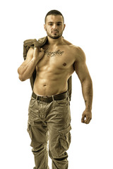 Confident muscular male bodybuilder during bulking phase or mass period, posing isolated on white.
