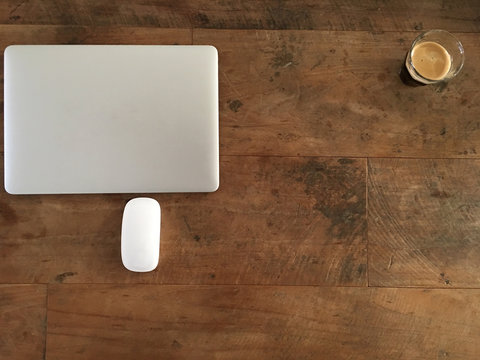 Laptop op bureau met koffie en muis