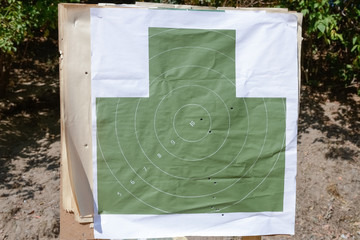 target with bullet holes on the shooting range