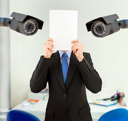 businessman covering his face at the office