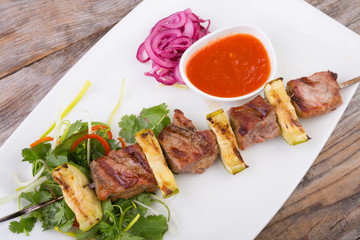 Fried meat on a metal skewer
