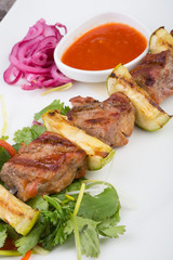 Fried meat on a metal skewer