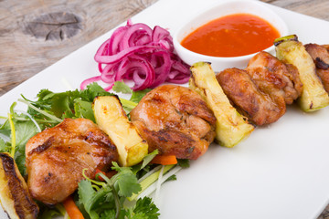 Fried meat on a metal skewer